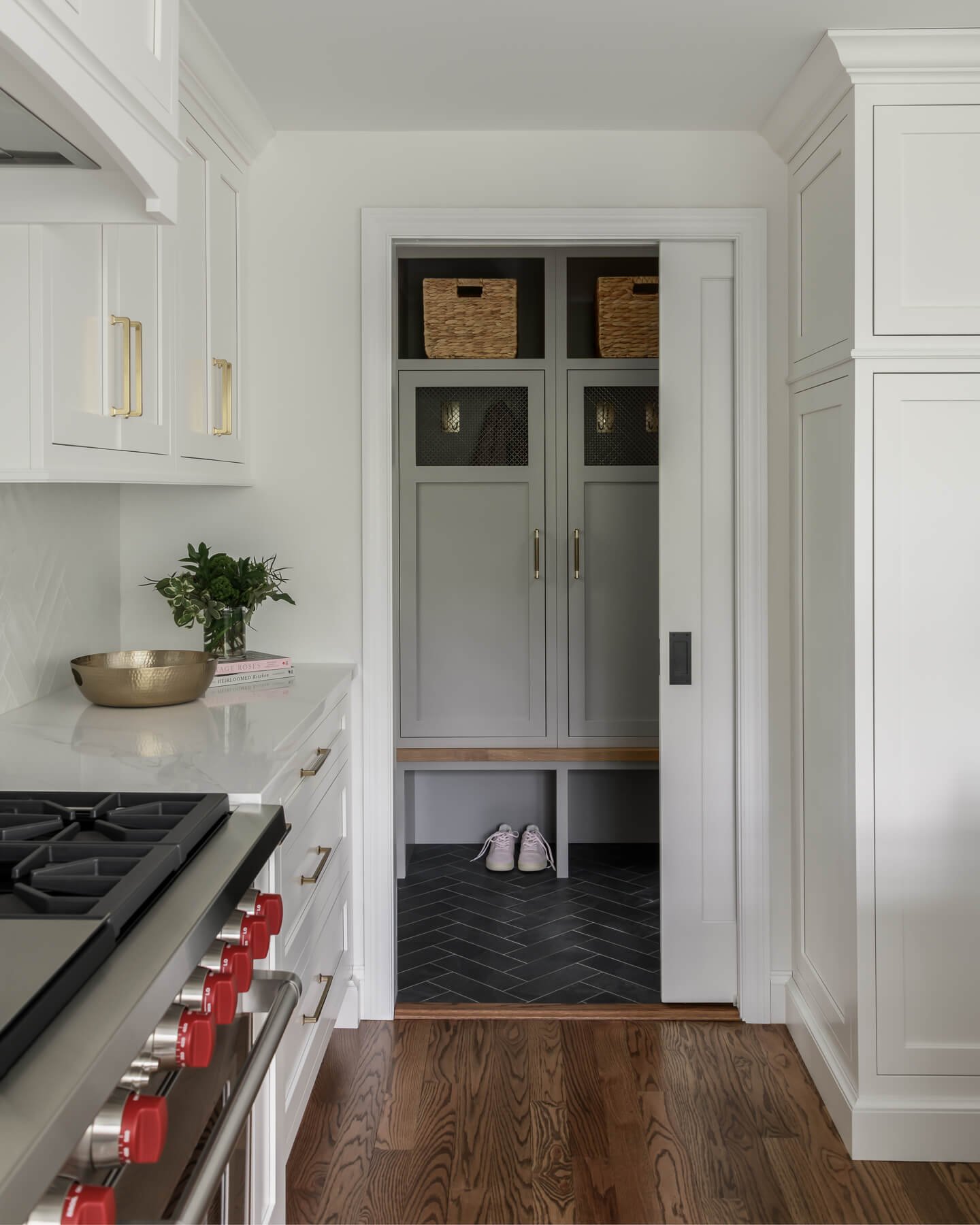 Kitchen and mudroom renovation in Cranford, NJ by Elements Interior Design Studio. The photo looks out from the kitchen past the stove into the mudroom. 