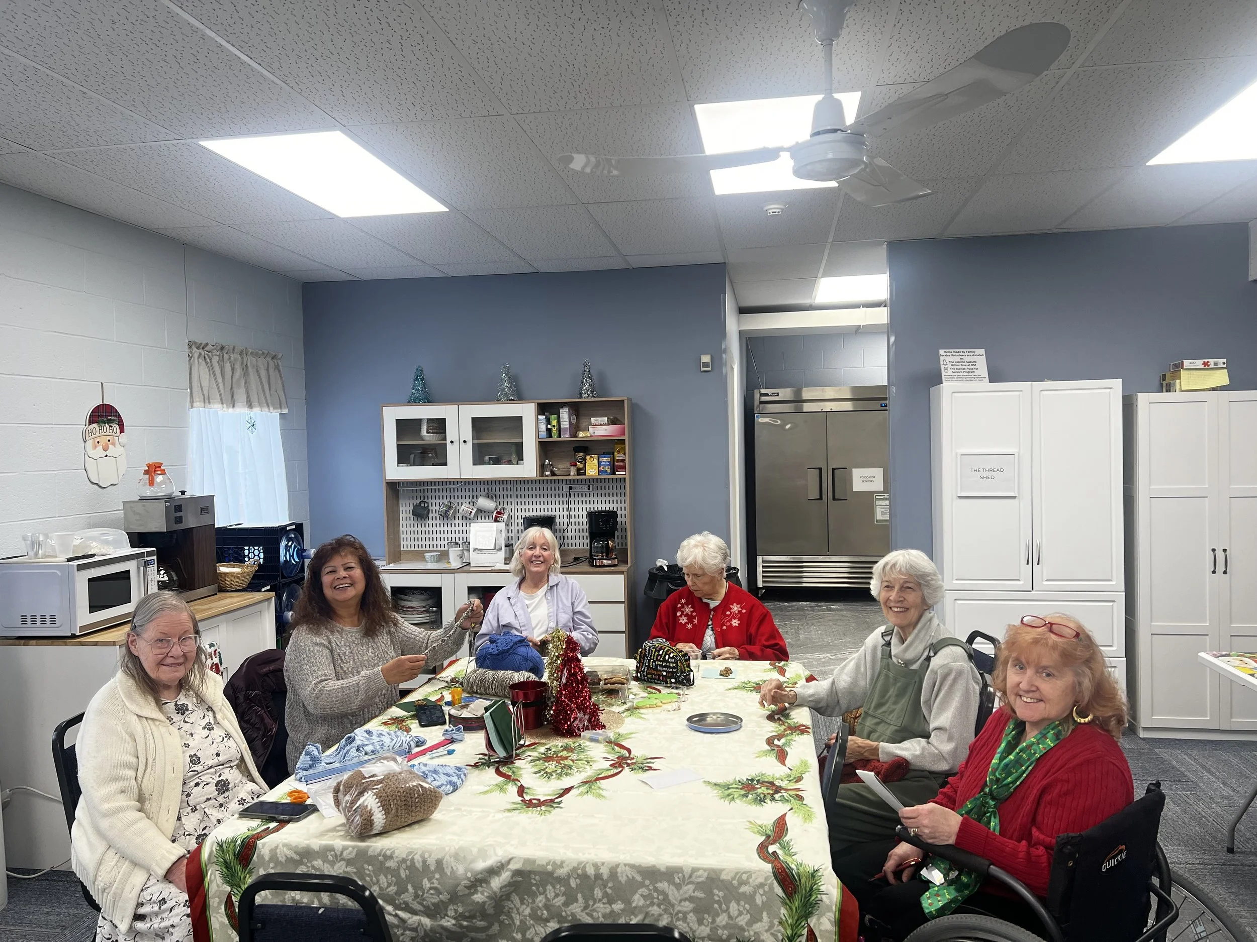 Our fun-loving needlework volunteers having fun and creating beautiful handmade pieces for our community - Family Service Cabutti Mitten Tree