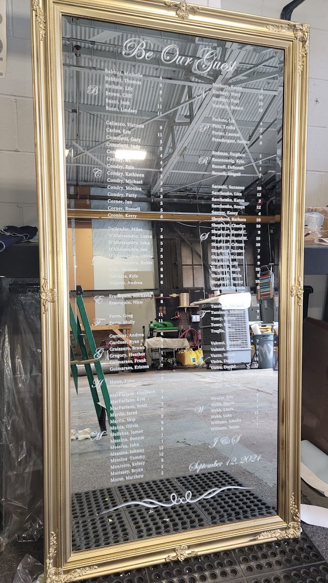 Cut vinyl applied to customer's mirror for a sesating chart.jpg