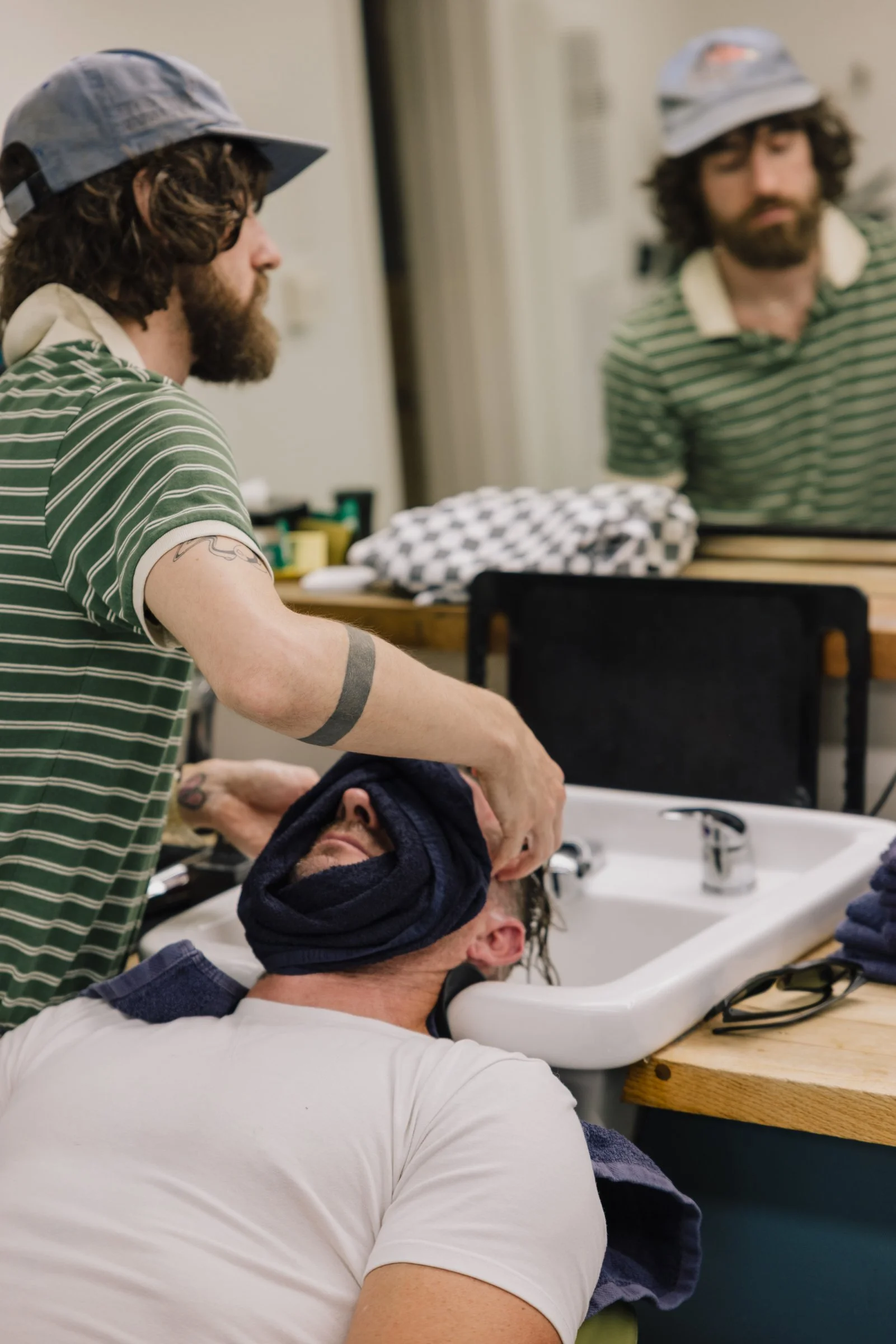 Barber chair wash station at Little Barber in Austin where clients receive relaxing grooming treatments.