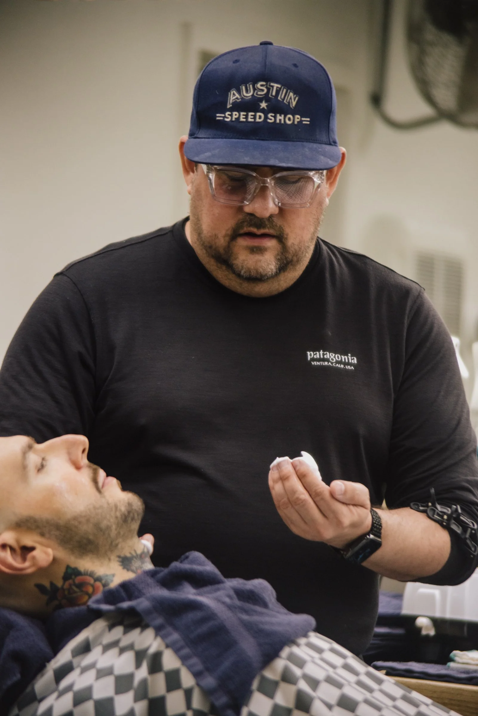 Professional barber consulting with a client during a grooming service at Little Barber Austin.