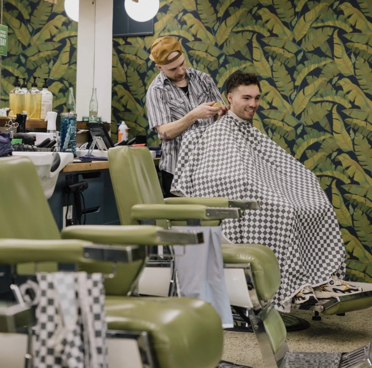Austin barber cutting a client’s hair at Little Barber, a modern men’s barbershop known for precision haircuts.
