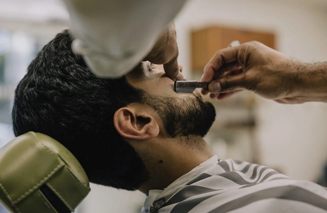 Straight razor beard lineup in progress at Little Barber Austin, highlighting detailed men’s grooming.