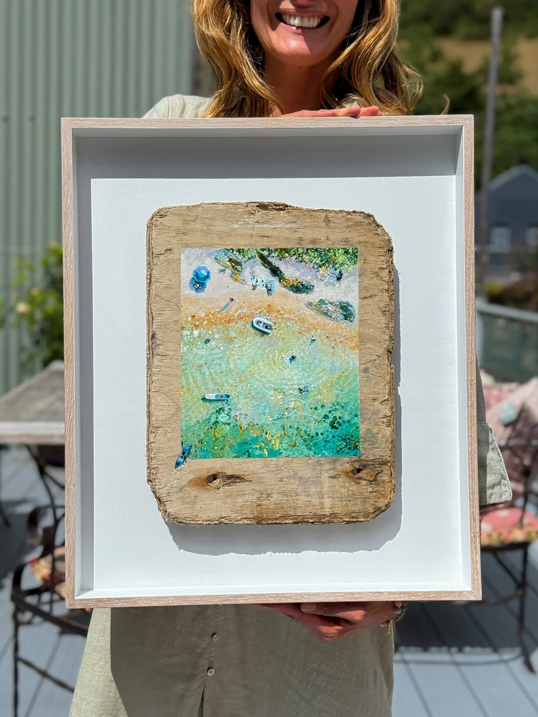 Lucy young showing her latest salcombe painting in interior design house, susie Watson designs