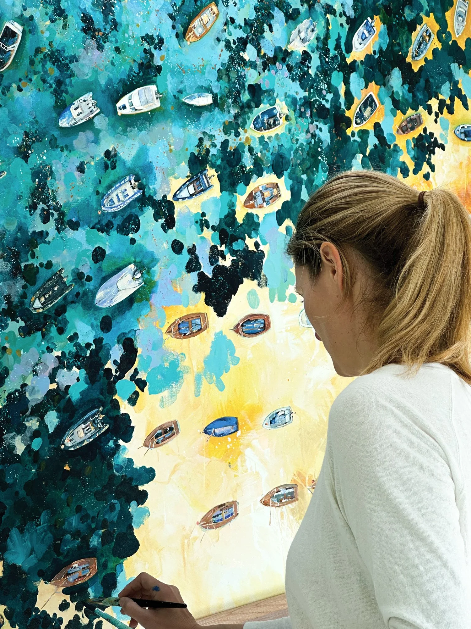 Explore "Rising Light," a contemporary original acrylic painting of Salcombe Harbour by Lucy Young. Featuring iconic wooden Salcombe Yawls and local boats moored on the estuary at dawn. A sophisticated study of South Devon maritime life.