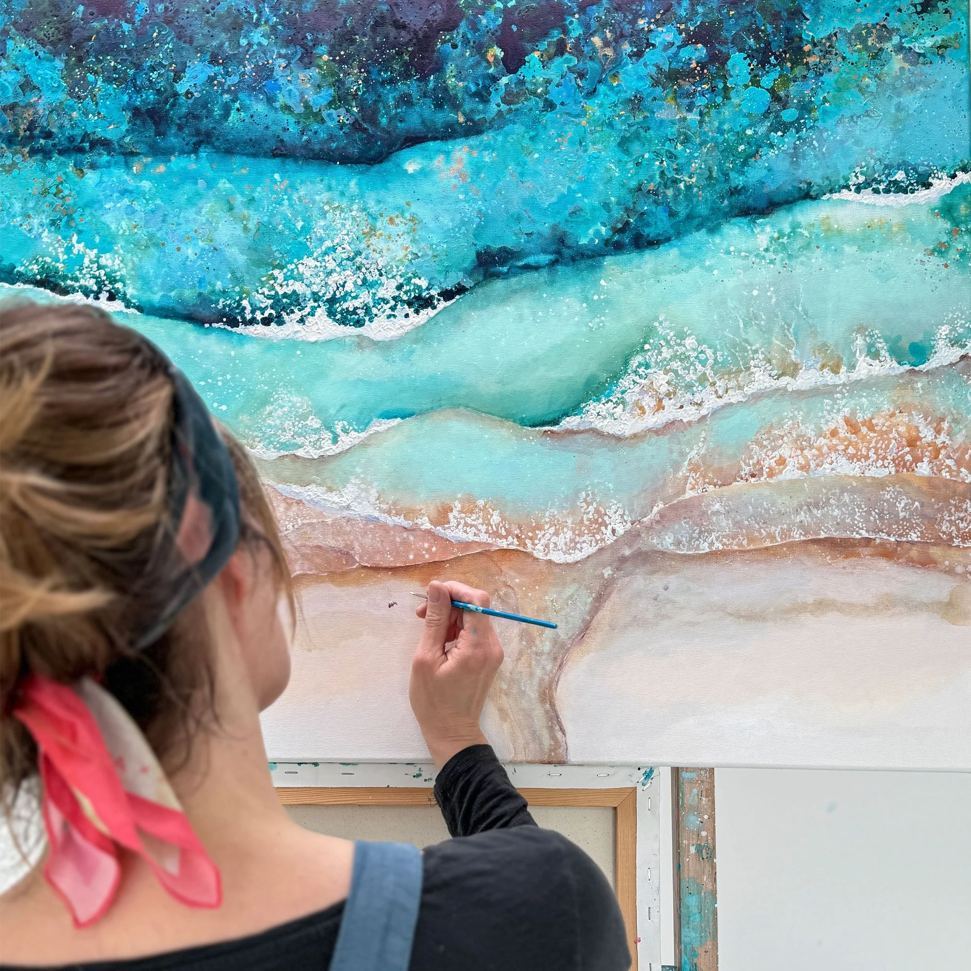 Custom aerial beach painting commission by Lucy Young featuring personalised family figures in the surf.