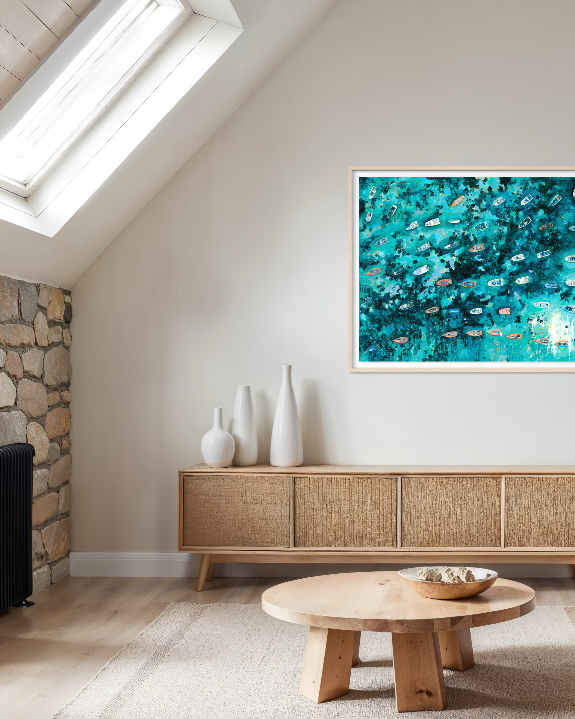 Framed Rising Light print of Salcombe Yawls styled in a coastal home with natural rattan furniture