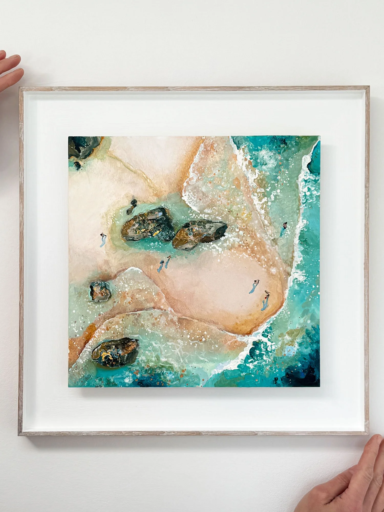 Mini original acrylic painting 'Rock Pool Roaming' by Lucy Young in a solid oak frame. Features a family exploring rock pools on a South Devon beach.