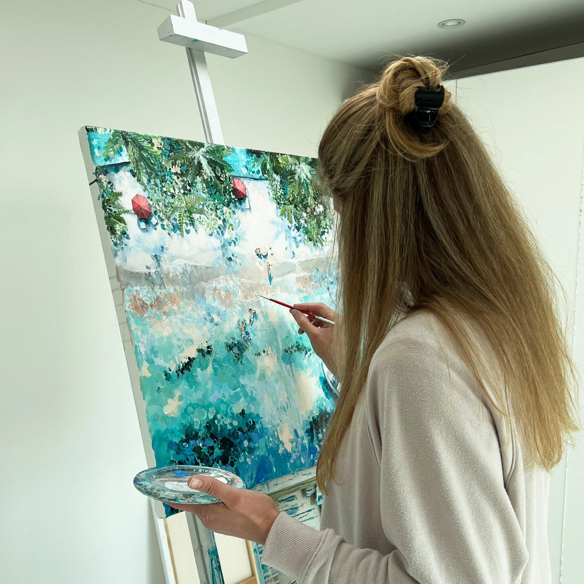 Original aerial acrylic painting 'Pure Paradise' by Lucy Young. Features a luxury Maldives resort beach with white sand, palm trees, a family on the shore, and a bobbing boat in turquoise water.