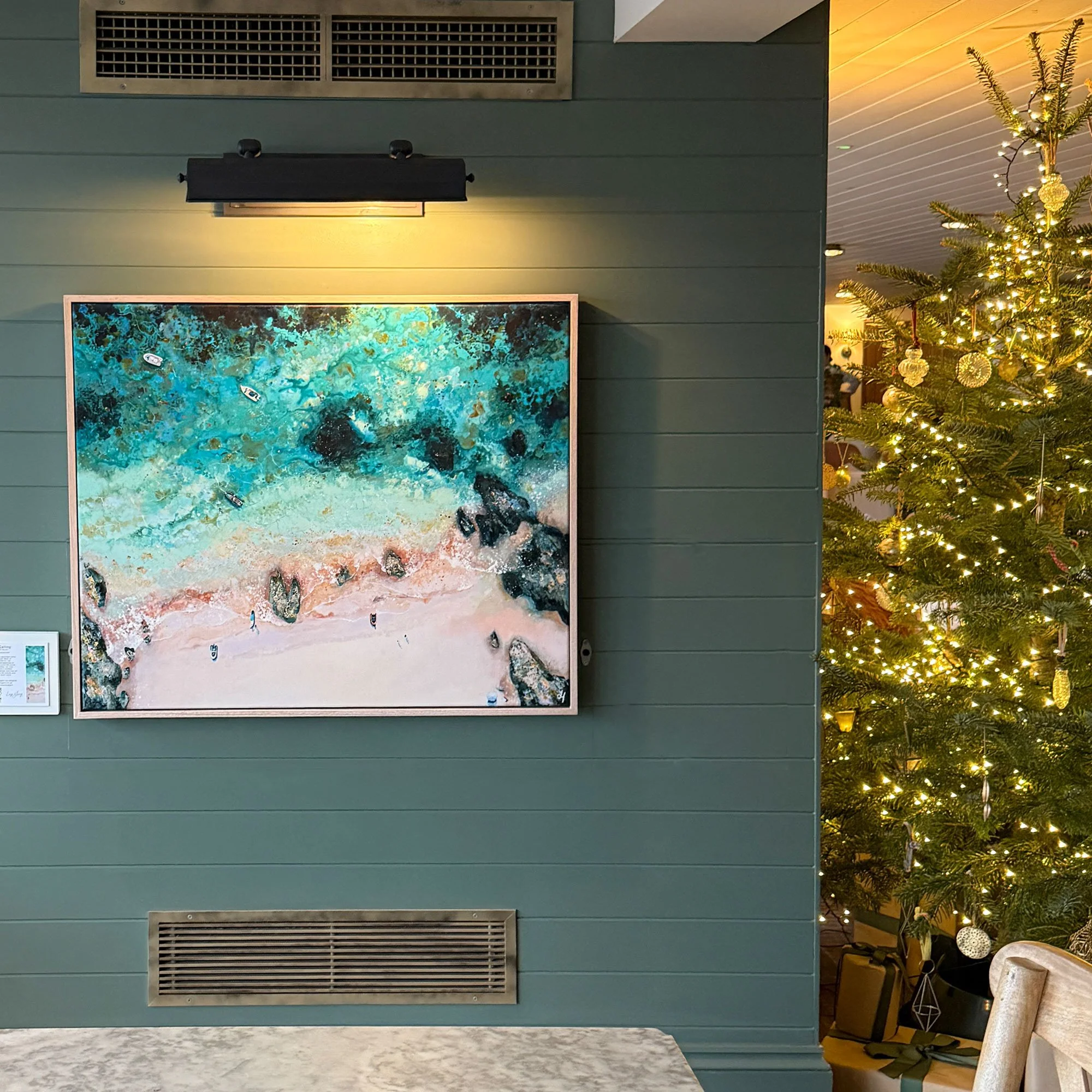 aerial seascape painting by, Lucy Young hanging in, gara rock hotel, Salcombe