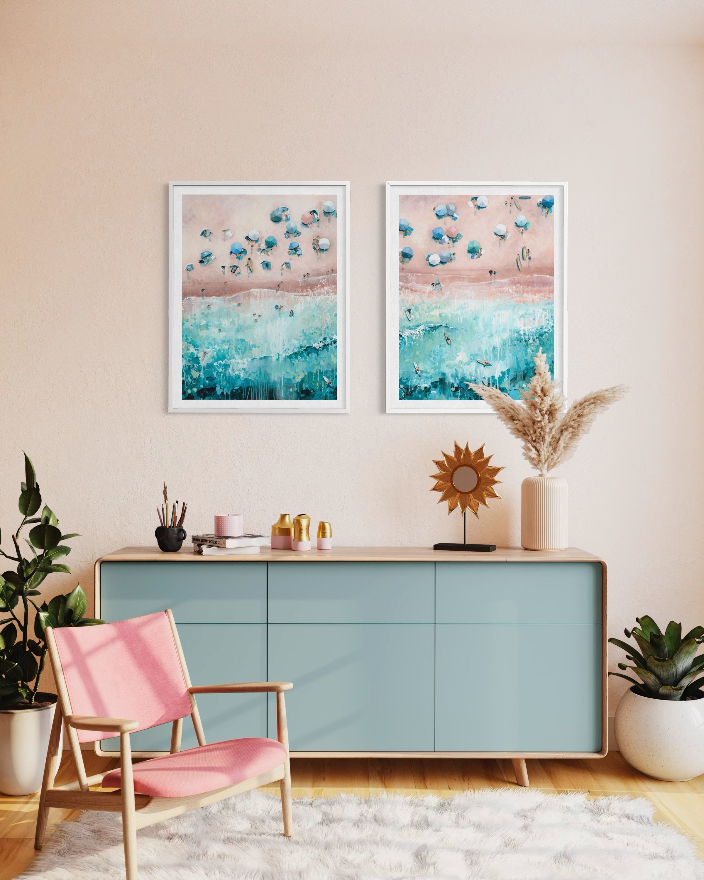 Large pair of blue and white coastal prints hanging side by side in a modern British living room with seaside theme.