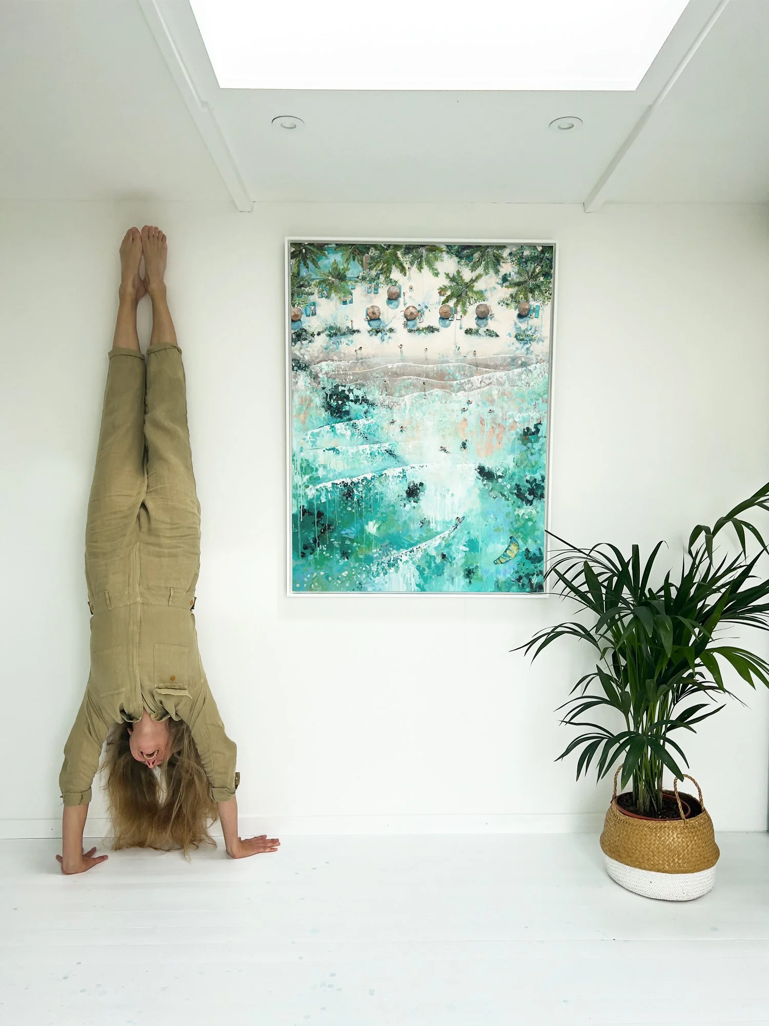 Large original aerial acrylic painting 'Sea Breeze' by Lucy Young. High-angle view of a Mauritius resort with straw umbrellas, palm trees, and a kitesurfer in turquoise waves.