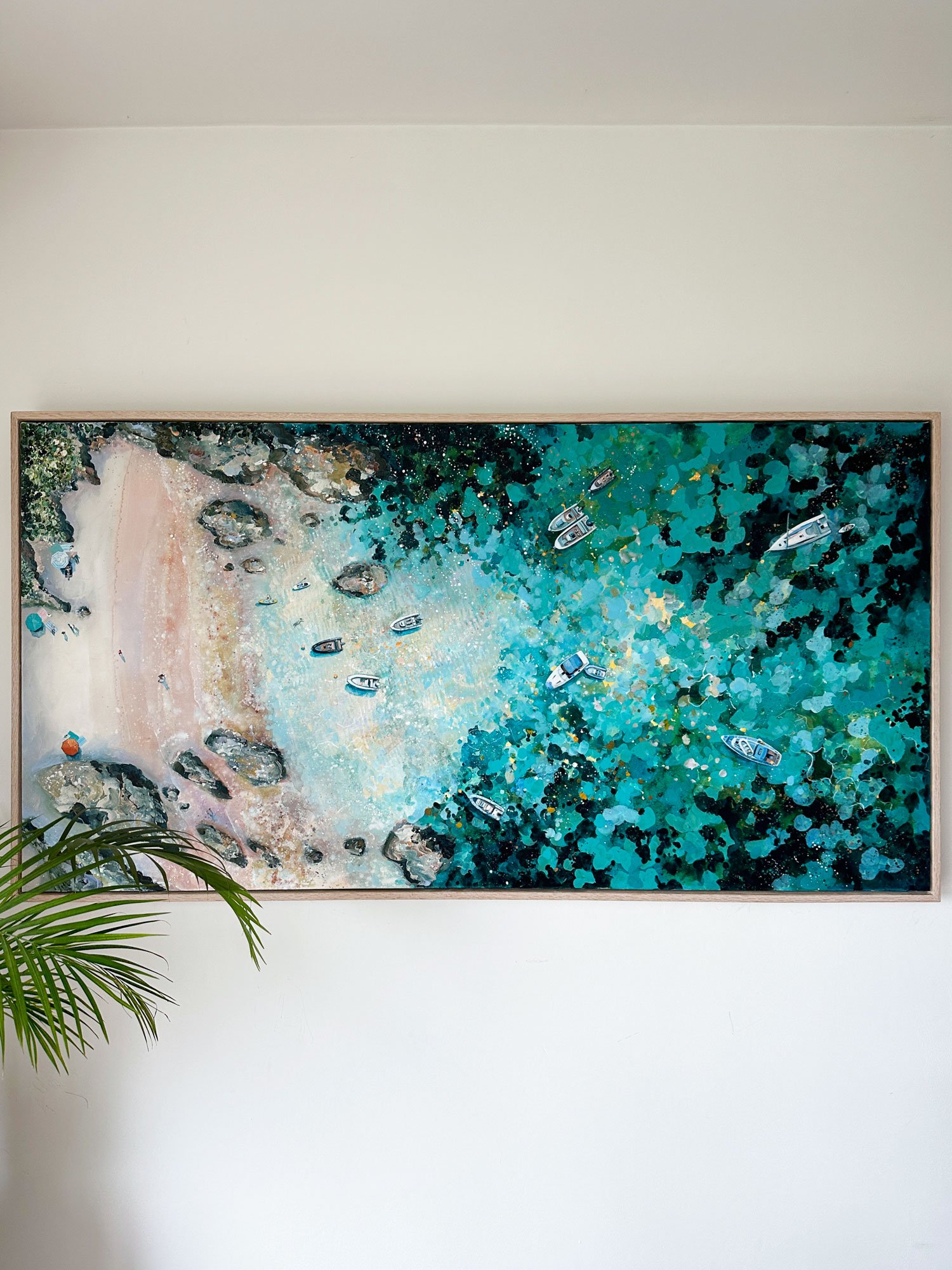 Explore "Secret Beach," an original acrylic painting of the South of France by Lucy Young. Featuring sparkling turquoise waters, moored yachts, and bobbing boats in a hidden Riviera cove. A contemporary statement piece capturing Mediterranean life.