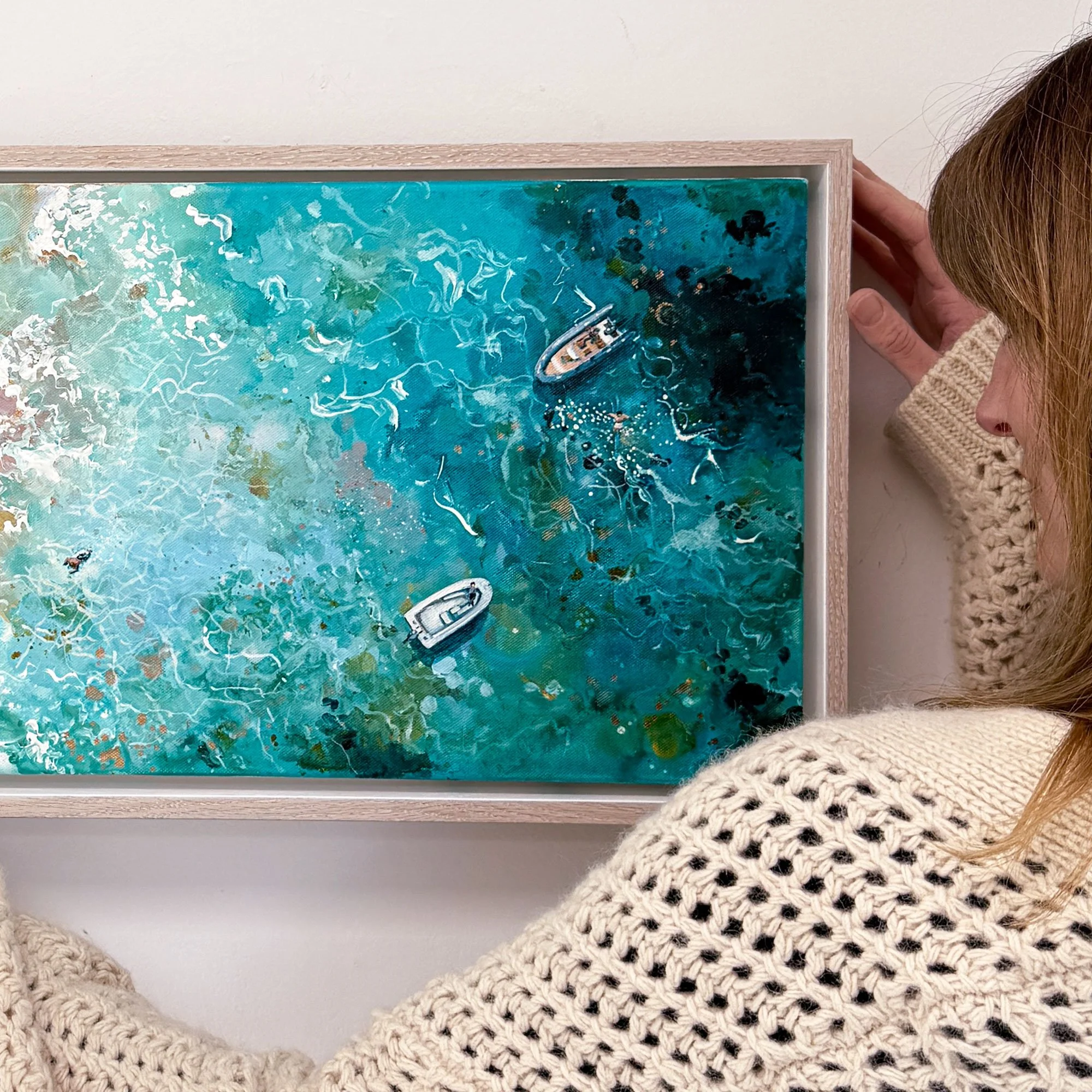 Discover "Coastal Rhythm," a panoramic original acrylic painting of a hidden South Devon cove by Lucy Young. Featuring a lone RIB boat, family explorers, golden sands, and turquoise surf. A contemporary coastal statement piece.