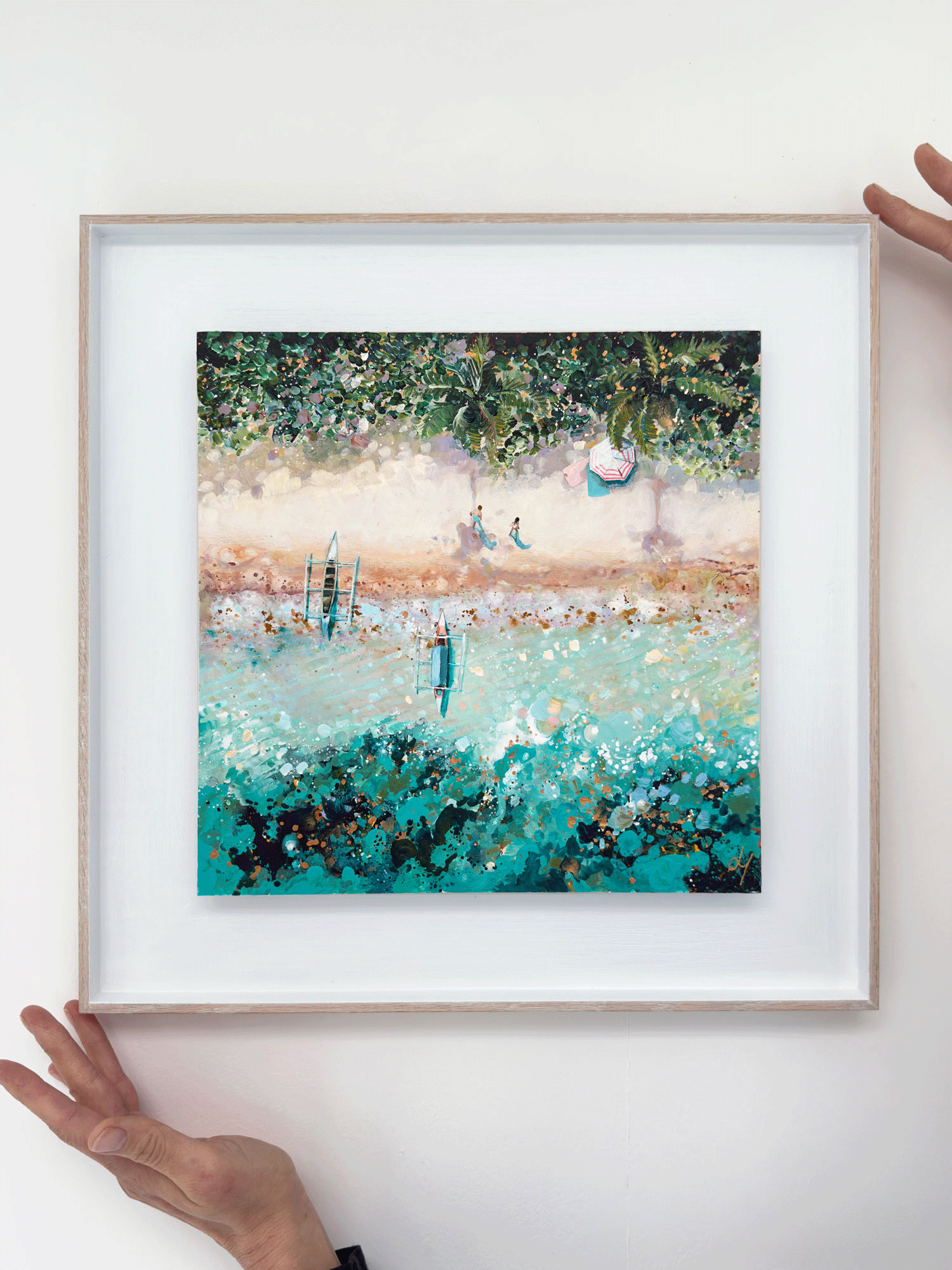 Mini original aerial acrylic painting 'Island Solitude' by Lucy Young. Features traditional wooden Indonesian boats on a white sand beach with lush palm trees and a couple walking.