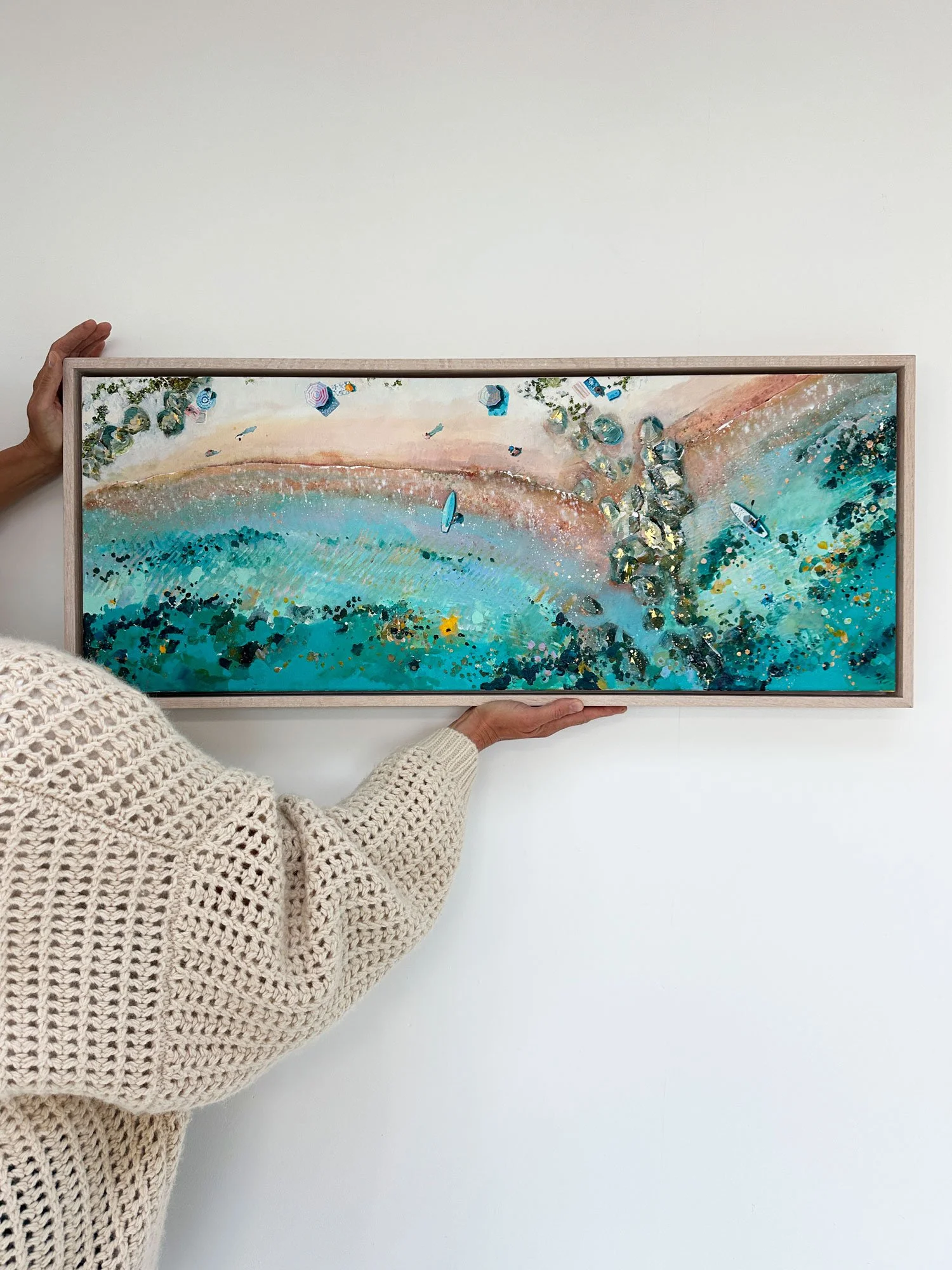 Panoramic original aerial acrylic painting 'Gentle Light' by Lucy Young. Features Mudeford beach in Dorset with rock breakwaters, mottled calm water, and a lone paddle boarder.