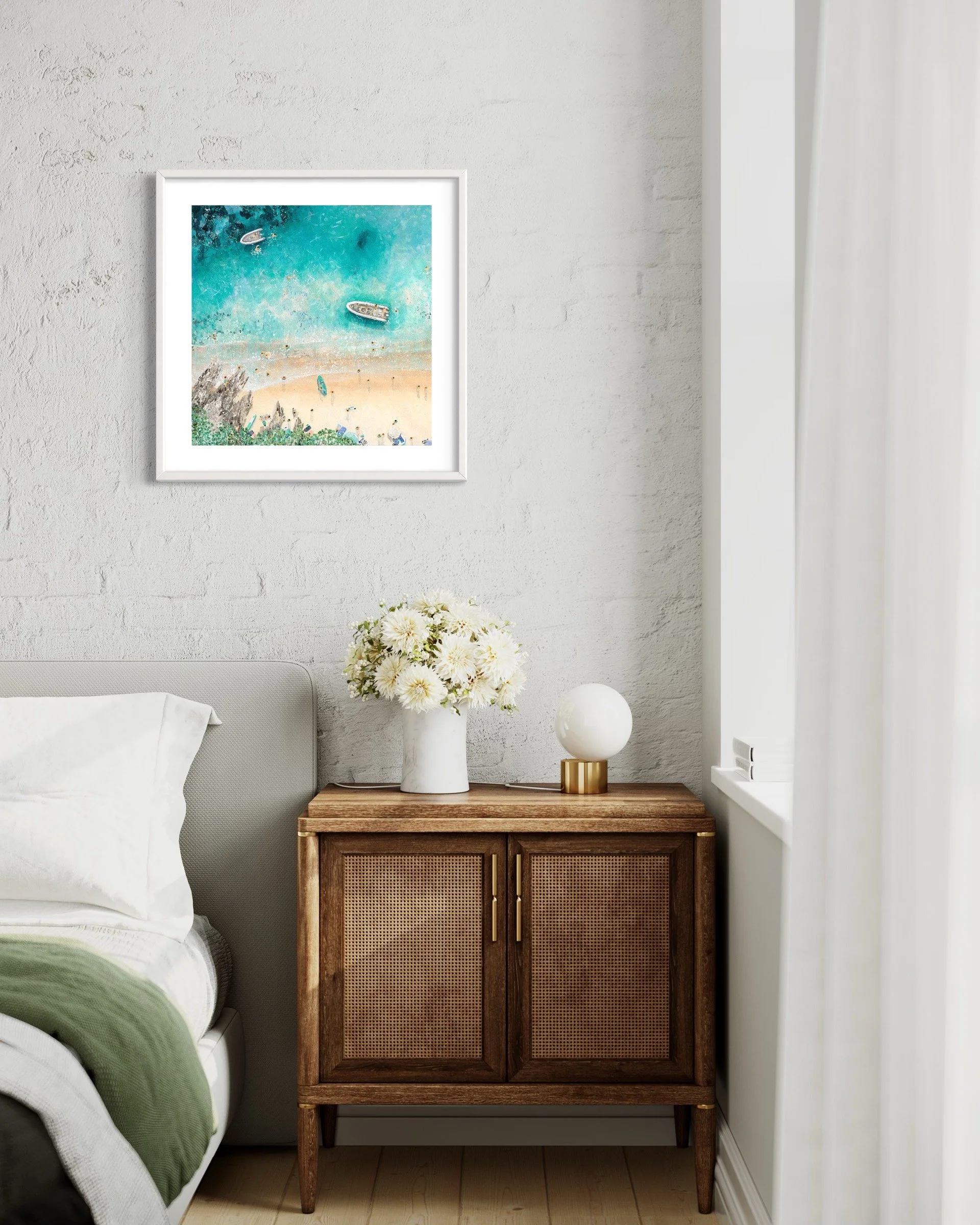 The Sunny Cove print styled in a small coastal bedroom, evoking a sense of coastal calm and summer memories