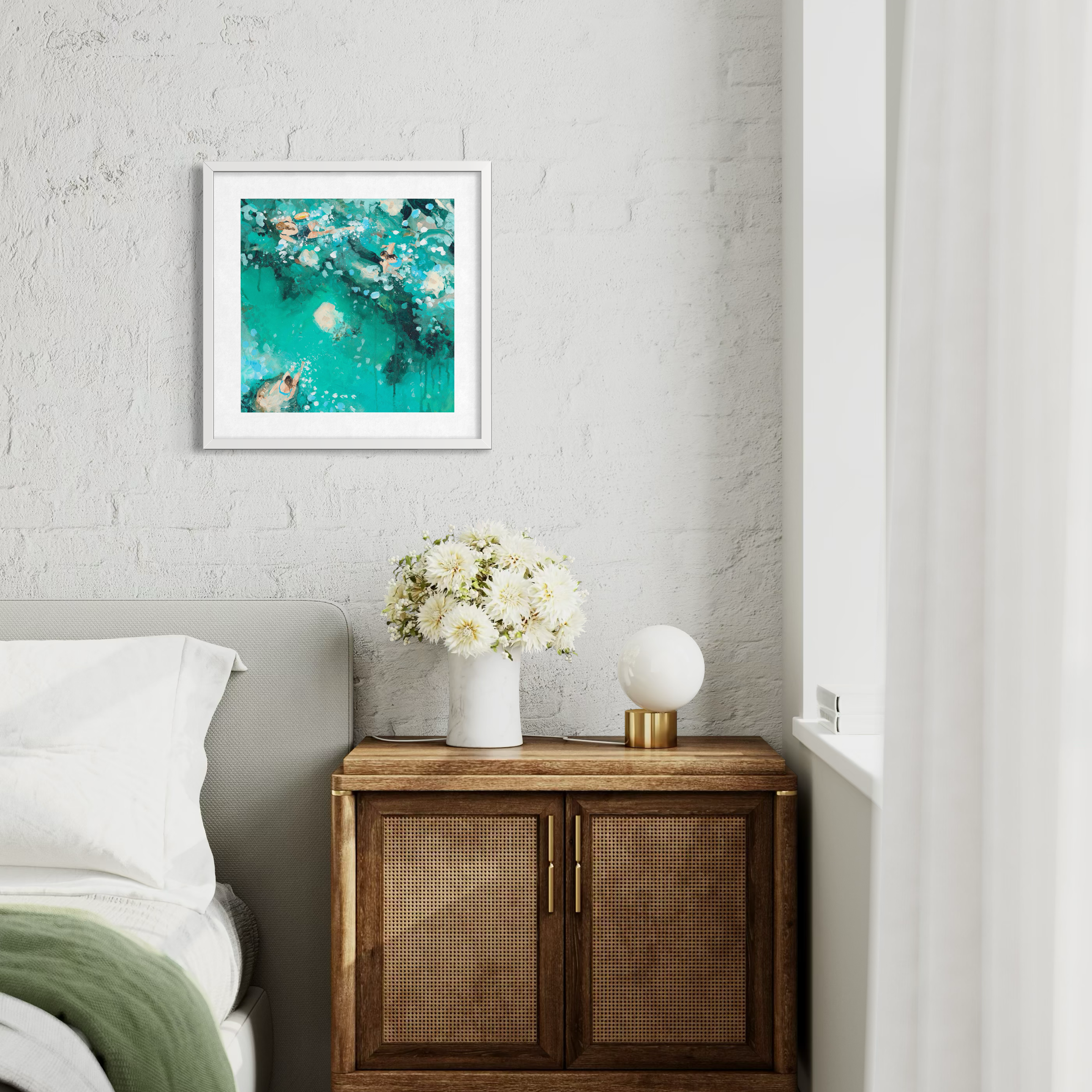 The Cold Water Kinship coastal print framed in a coastal cottahe bedroom, celebrating the spirit of outdoor swimming and friendship.