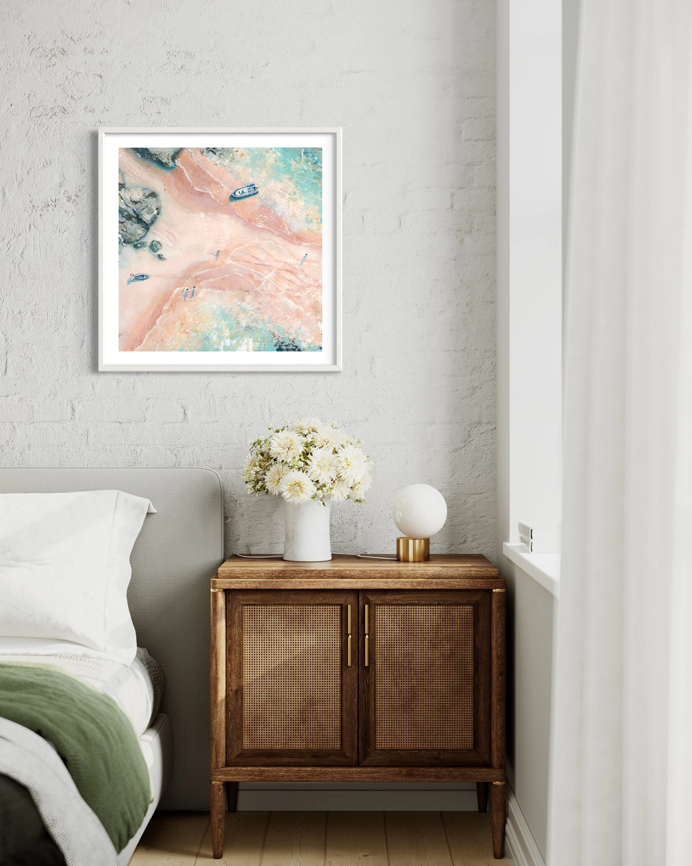 A framed print of The Hipple beach styled in a bright, modern, British coastal Interior with a natural theme.