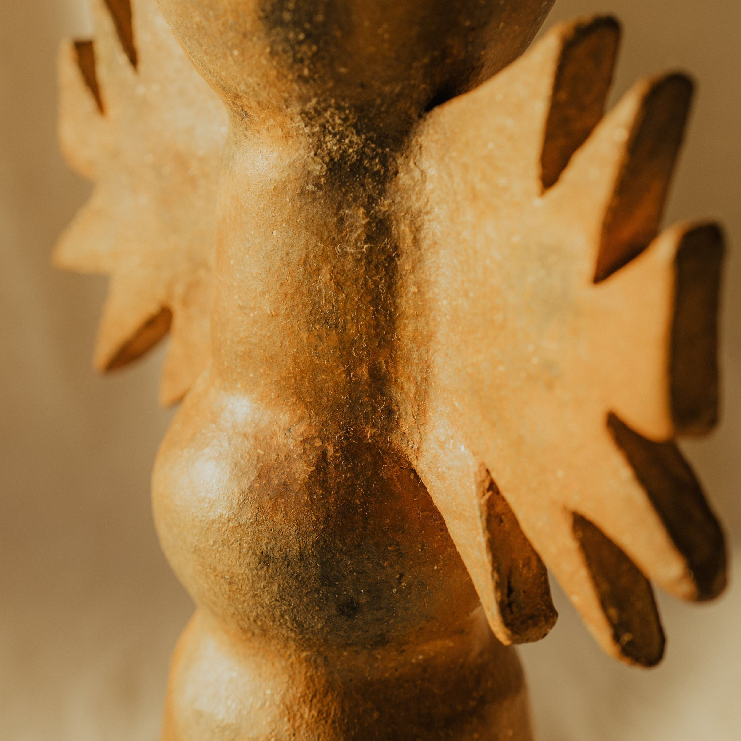 Close-up of a metallic gear or cog with serrated edges, showing signs of rust and wear.