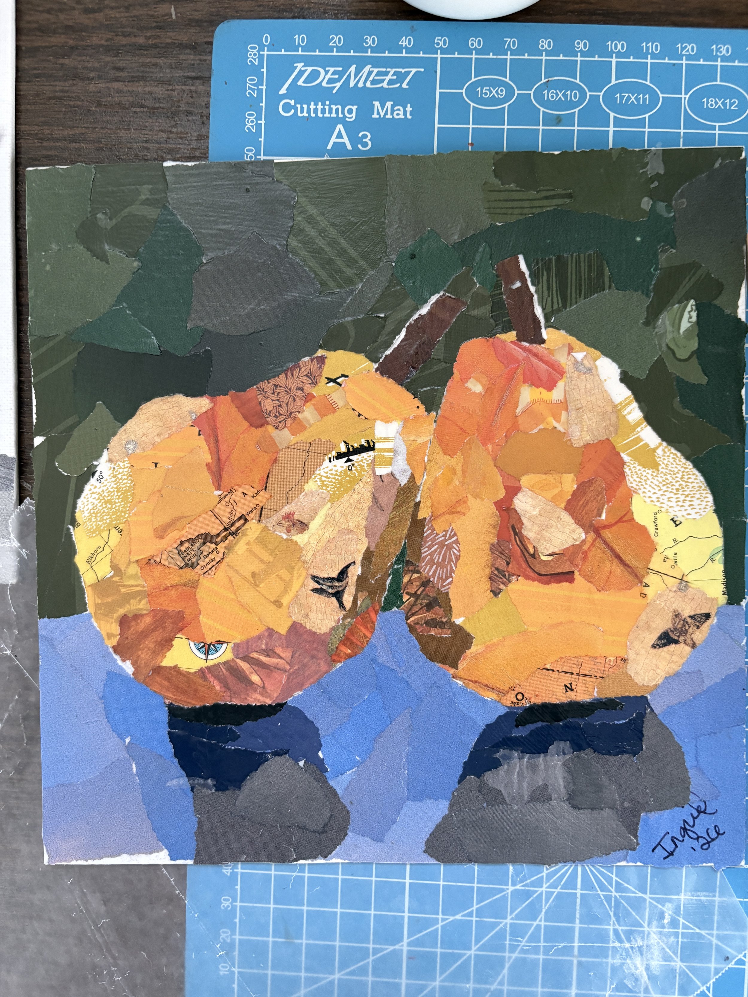 Still life with pears - these golden pears sit on a blue surface with a dark green background. Original handmade torn paper collage from recycled book materials. $100 message me to buy. 