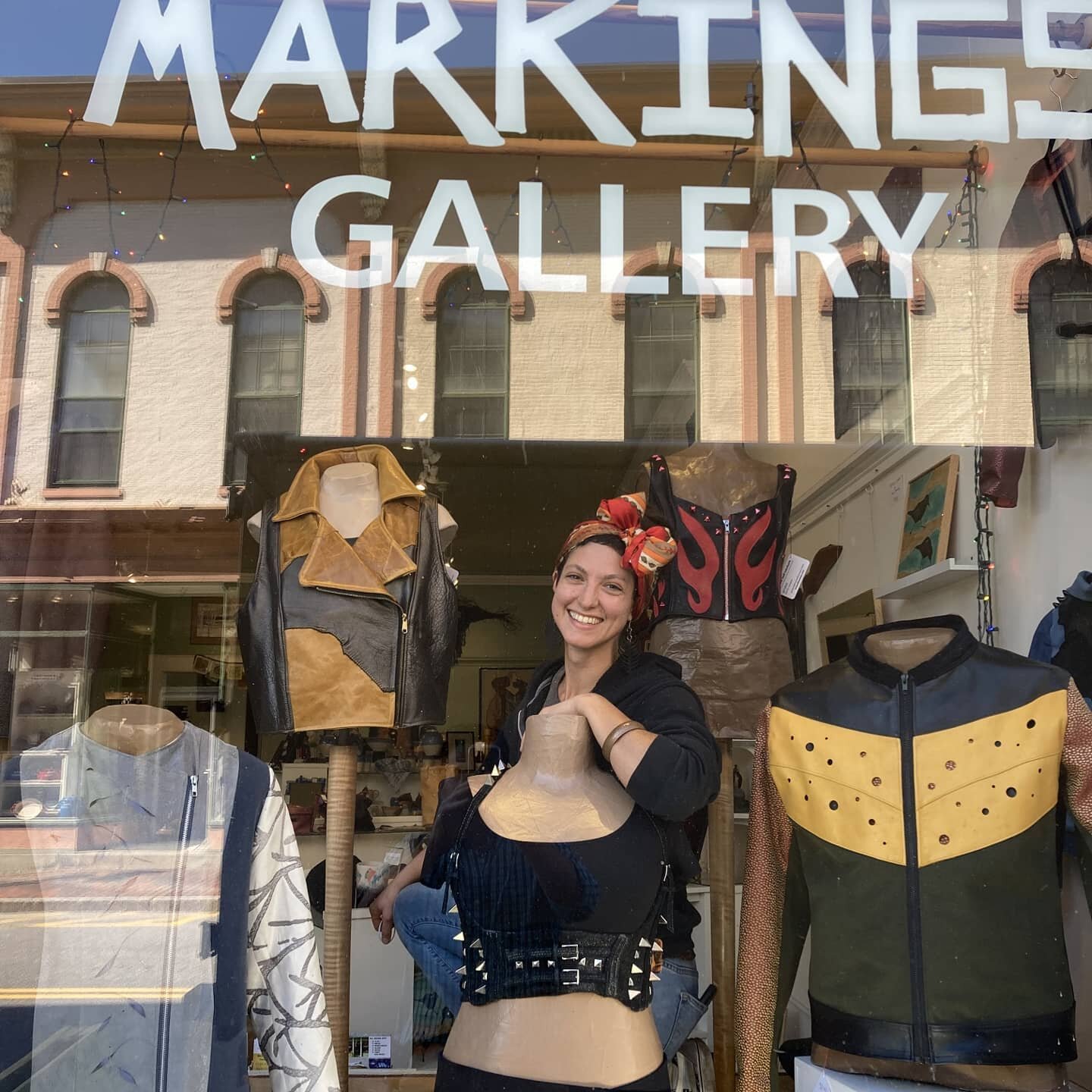 Check us out! @markingsgallery 

Jackets, tops, vests &amp; bustiers made with locally sourced #recycledleather . @gnykol caught fluffing the display. Who knew dressing mannequins would be on this year's roster?

See the full trunk show on October 9!