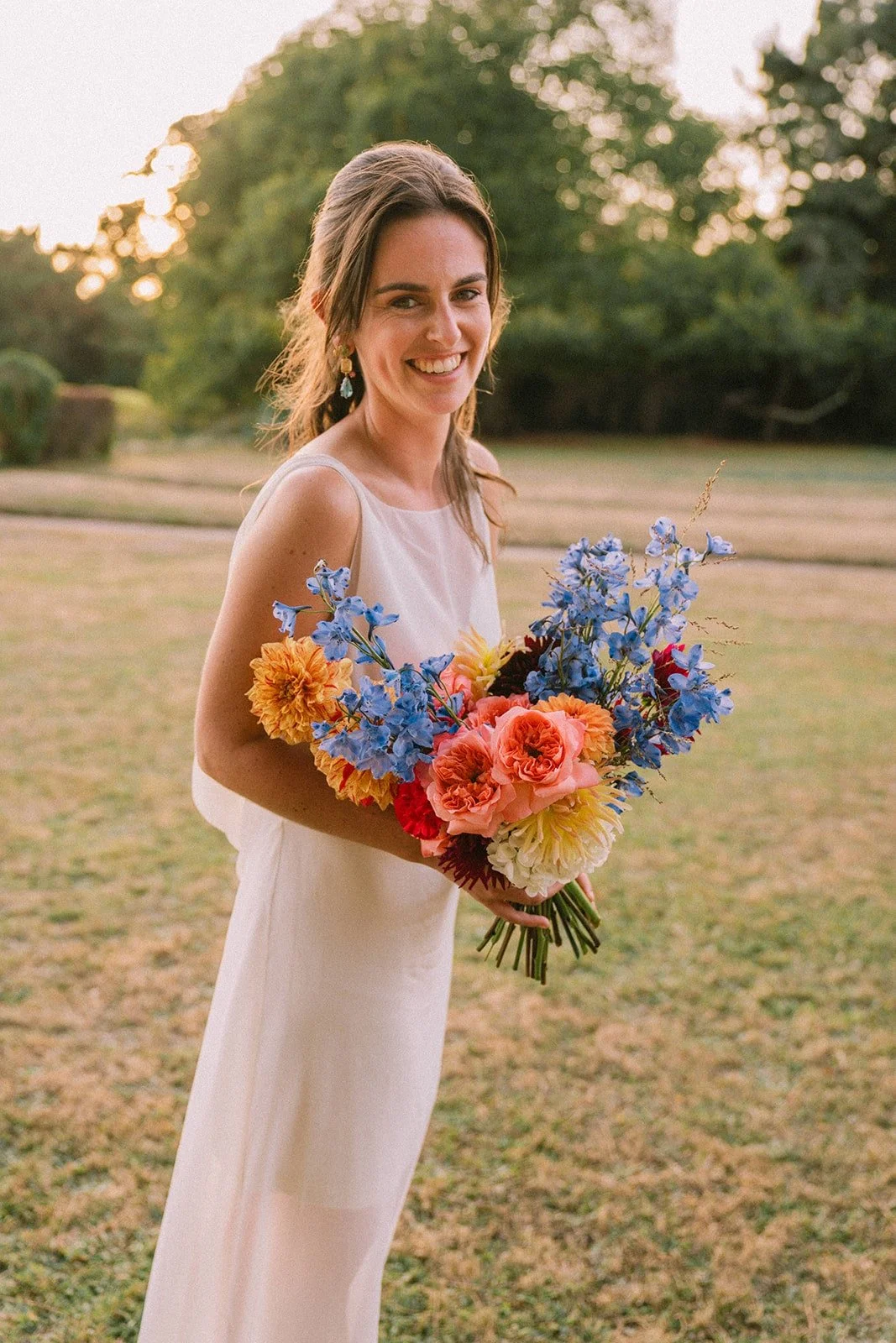 Jeune femme mariée avec son bouquet, bouquet multicolore, dahlias
