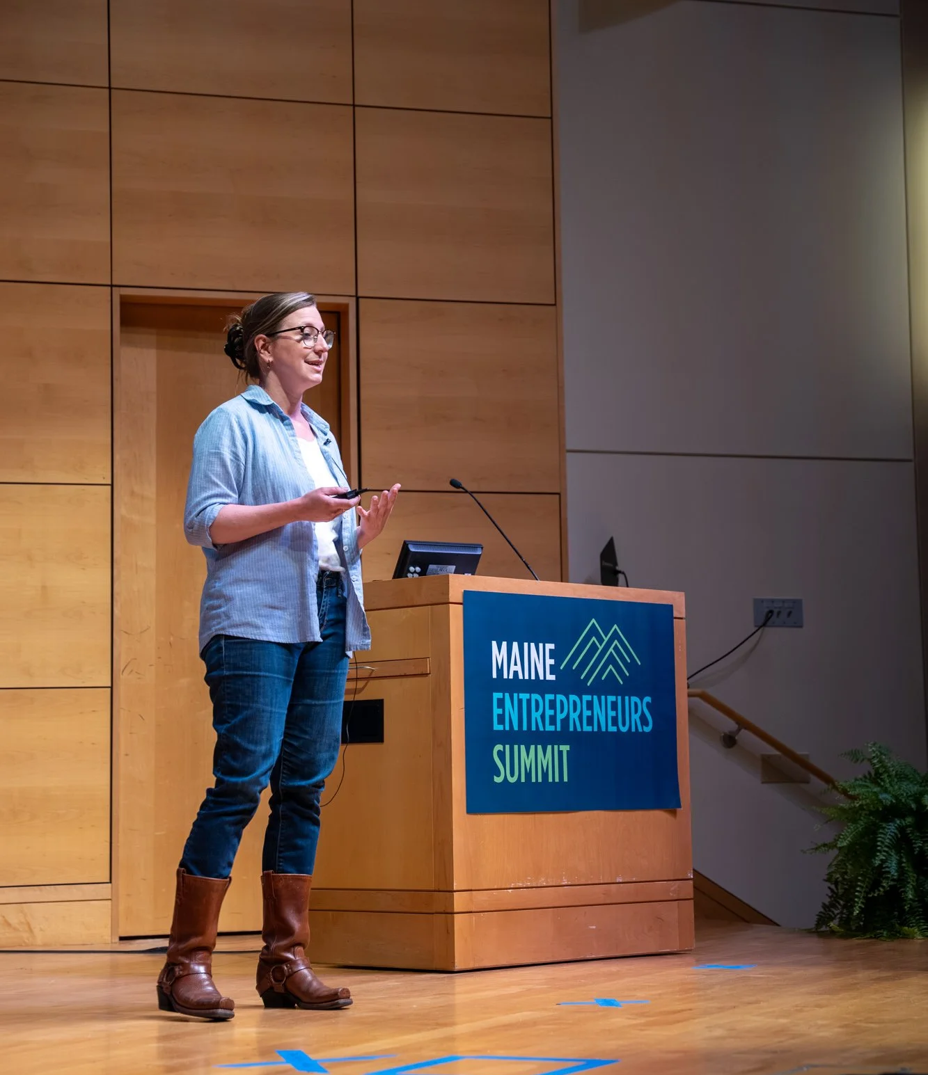 a woman on a stage giving a presentation
