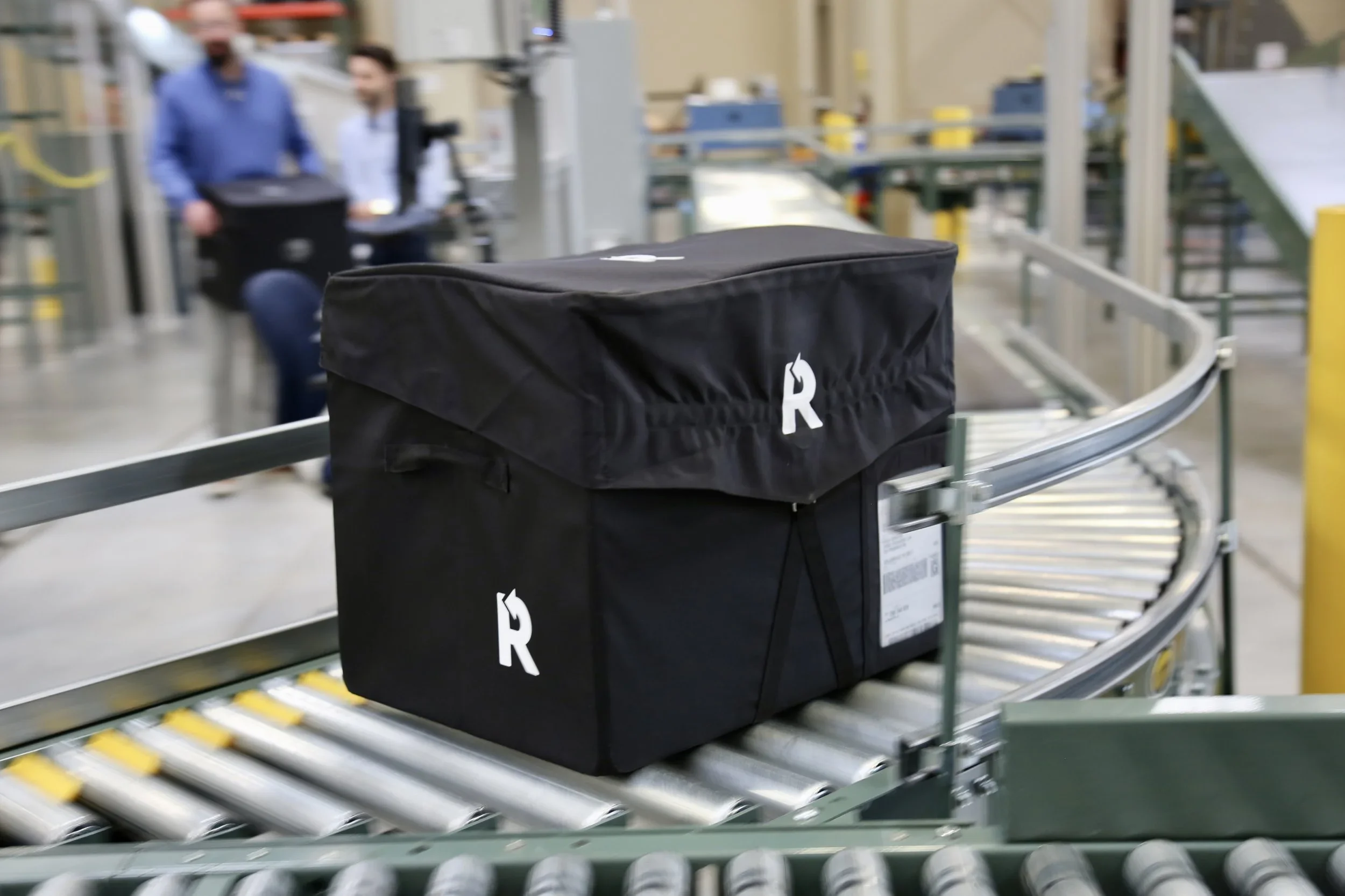 reusable shipping box on a conveyer belt