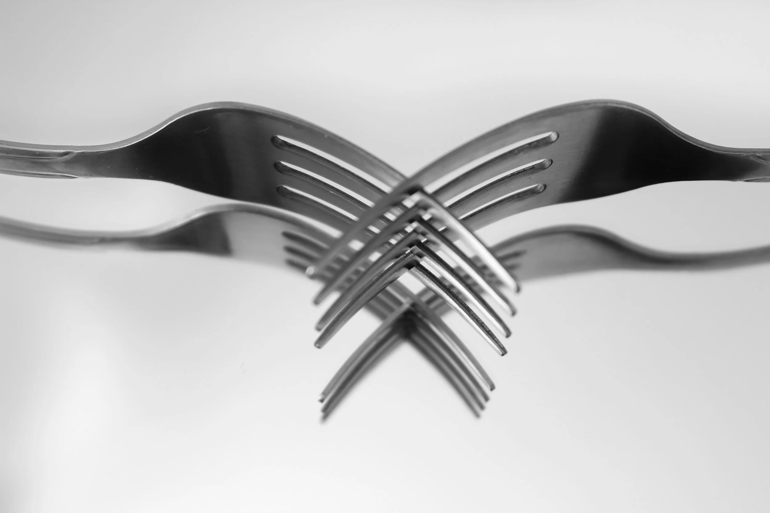 two metal forks intersecting