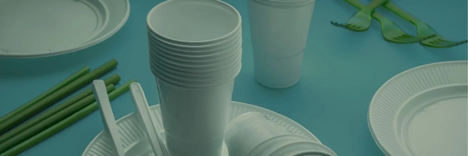 plastic cups and plates on a blue background