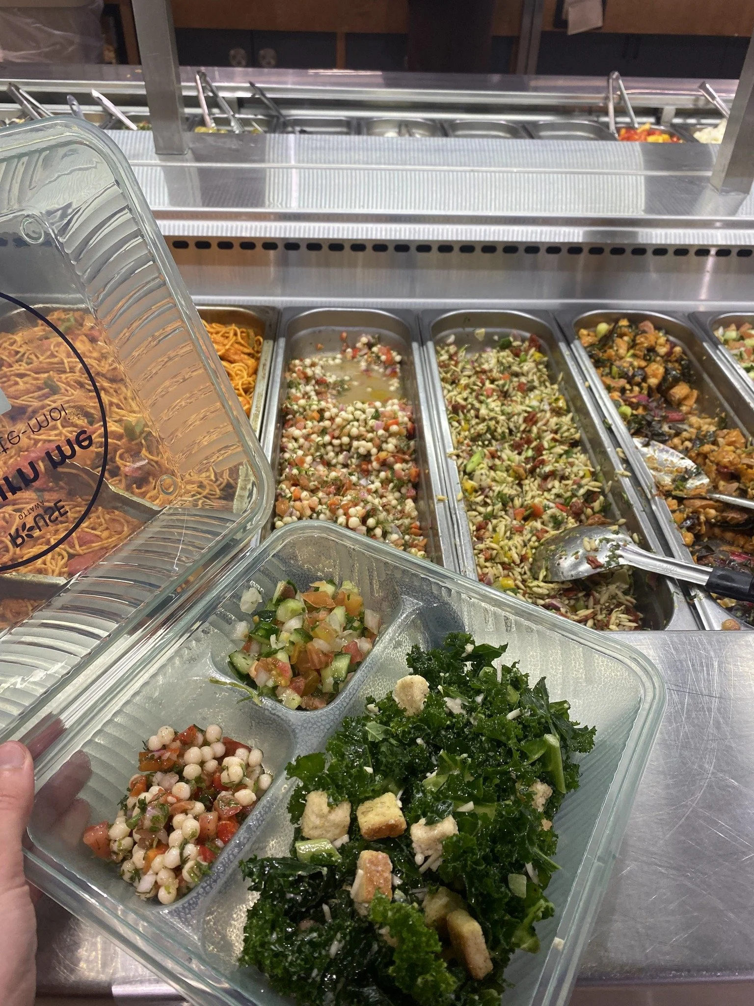 reusable container next to a deli buffet