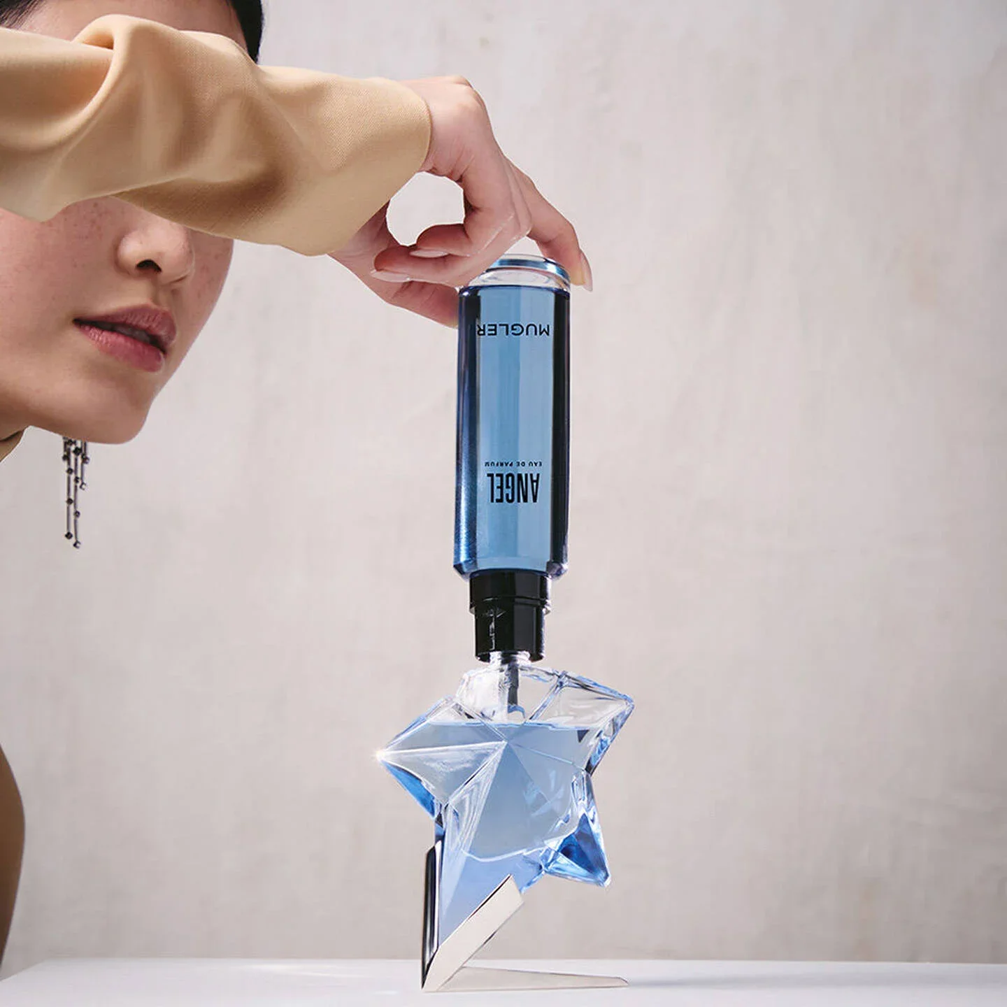 Perfume bottle being refilled