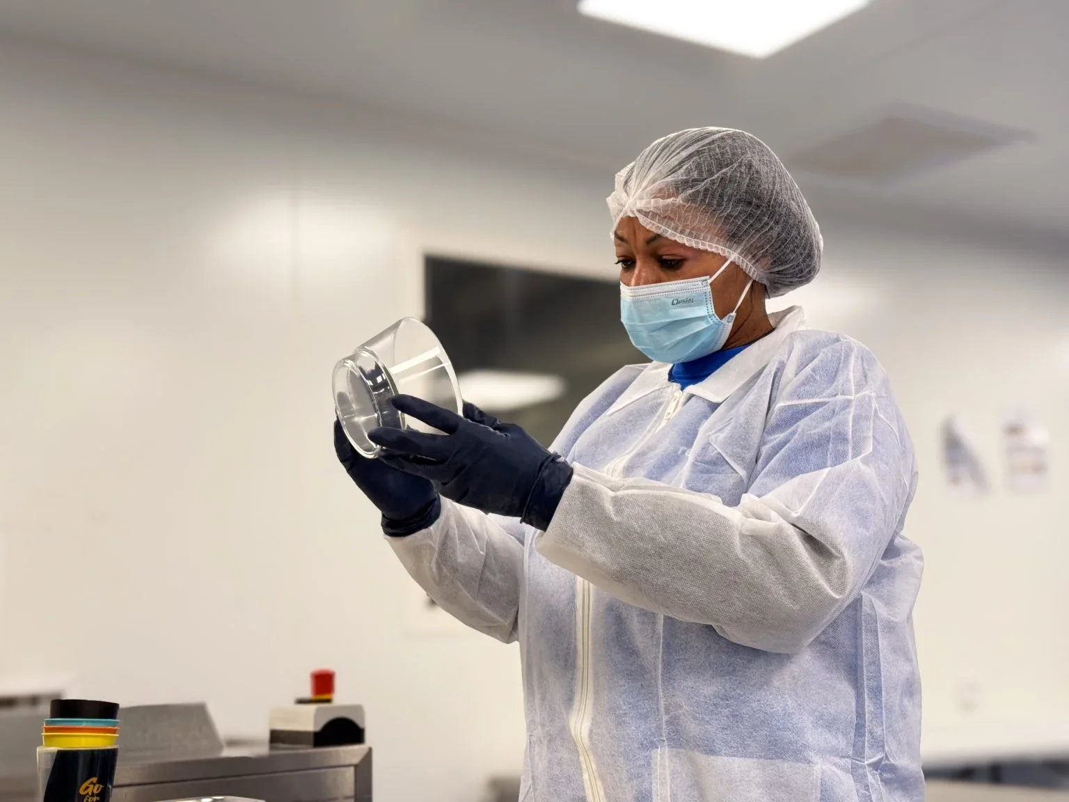 a woman inspecting a cleaned dish