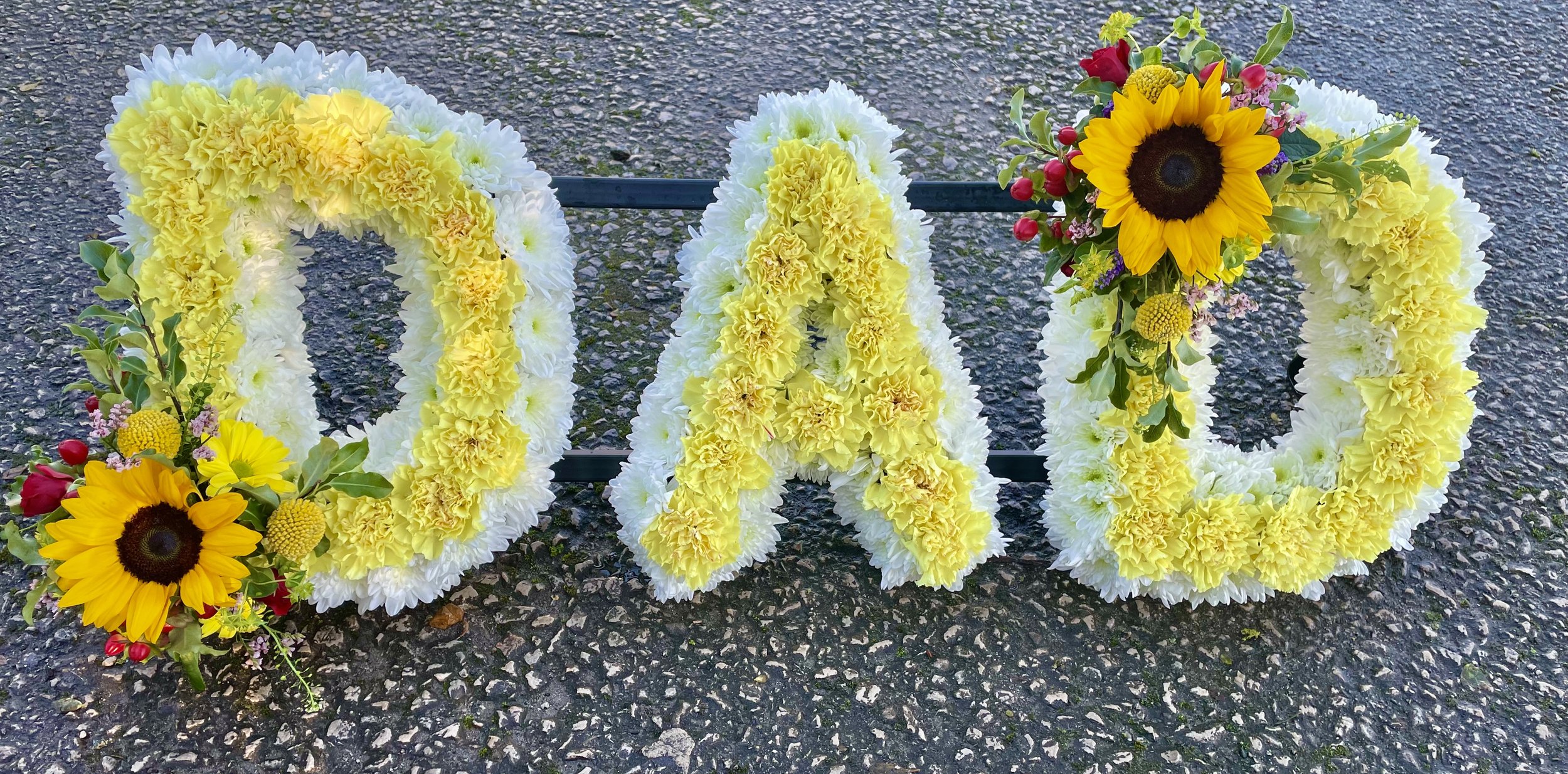 DAD funeral flowers with yellow carnations