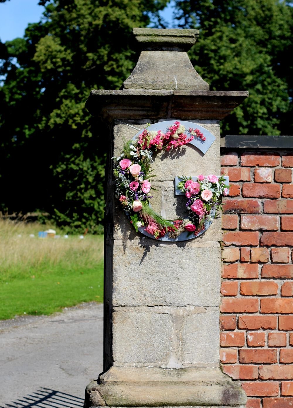 Initials in flowers on the entrance pillars at Meols hall