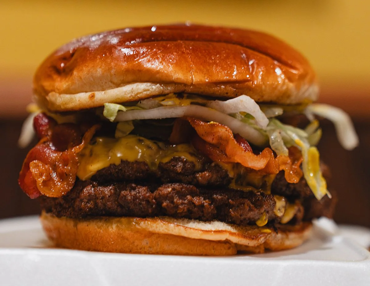 A big fat juicy burger dressed with all the fixings and bacon.