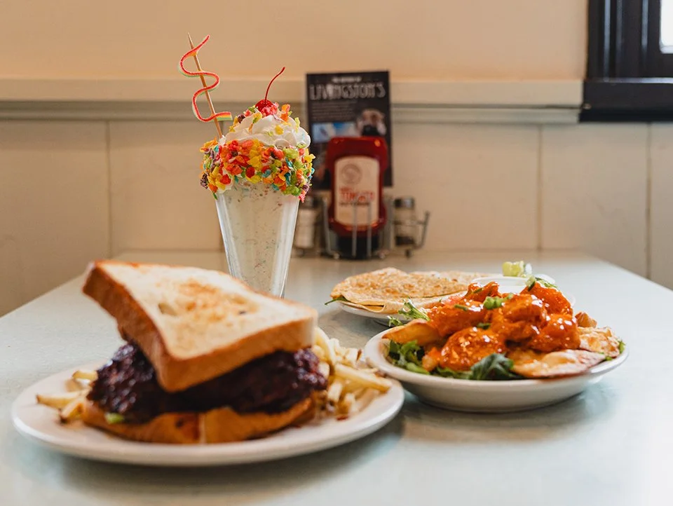 A colorful  milkshake is surrounded by a hot chicken sandwich, Boom Boom shrimp and Southwest quesadillas' - a few favorites at Livingston's Soda Fountain in Brownsville TN.