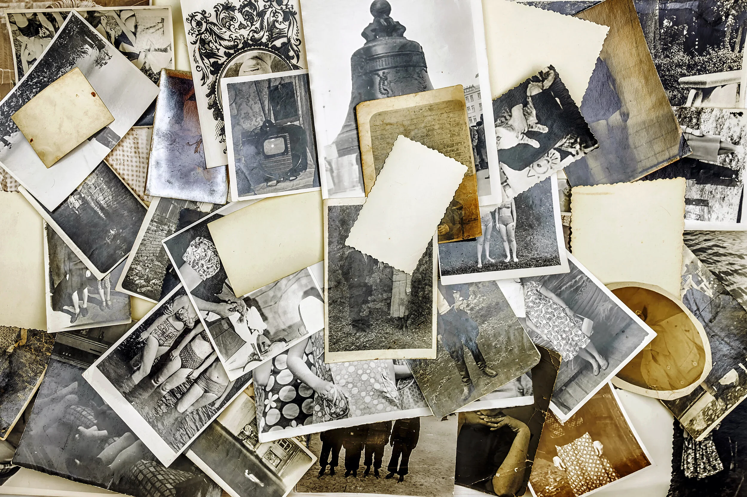 A pile of photos haphazardly displayed on the desk