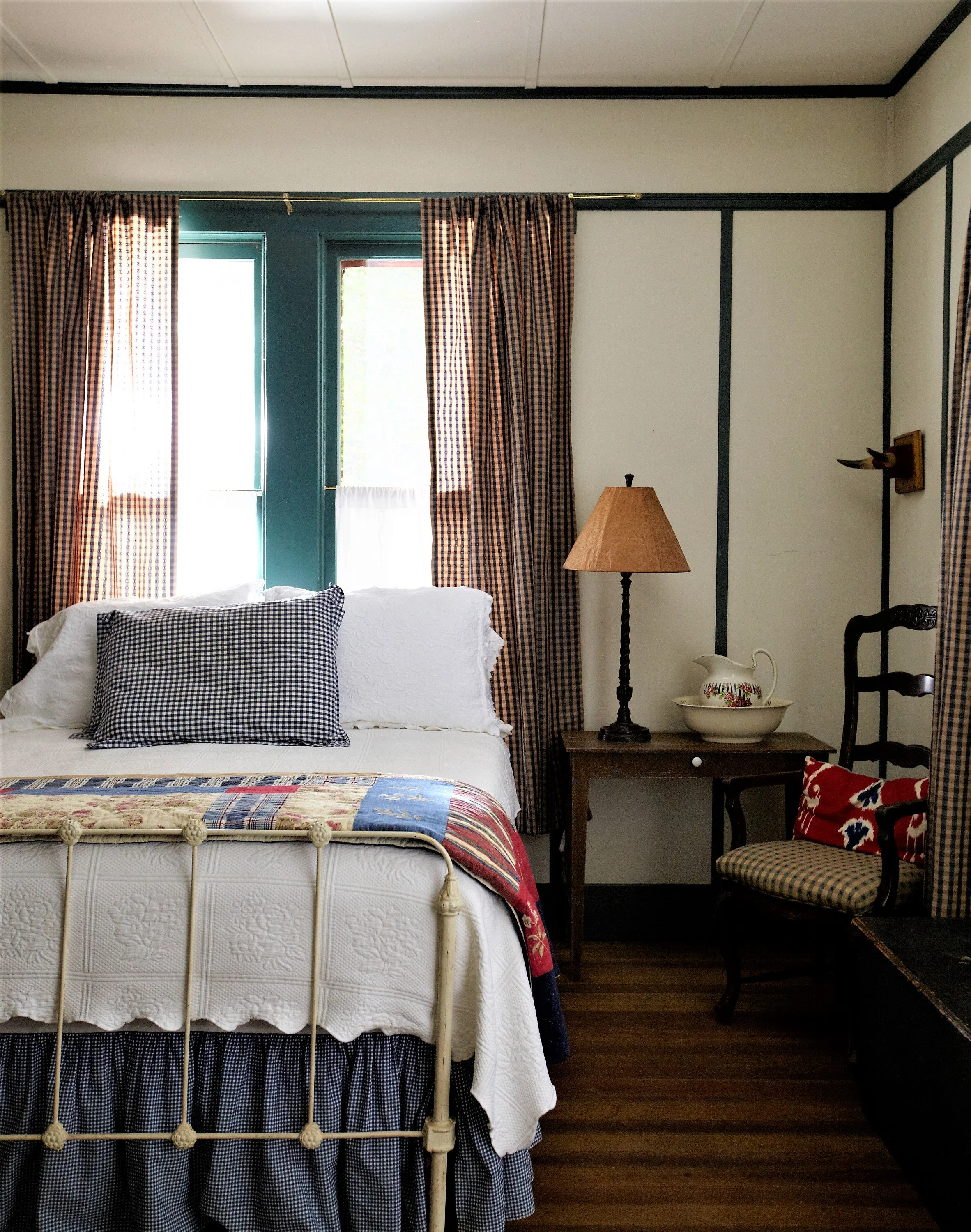 interior bedroom with checkered curtain and lamp