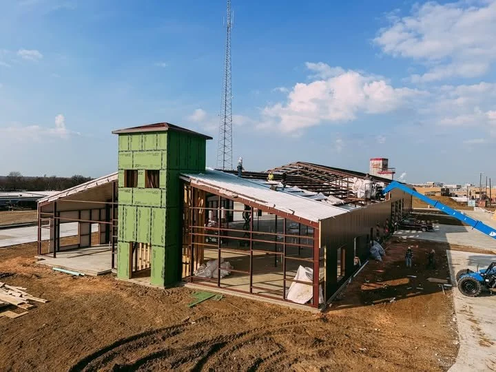 Commercial building steel frame construction with green sheathing by Bobby Smallwood Construction.