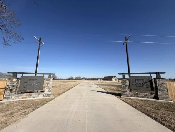 Stone masonry entrance monument for Bridgewater residential community with paved driveway.