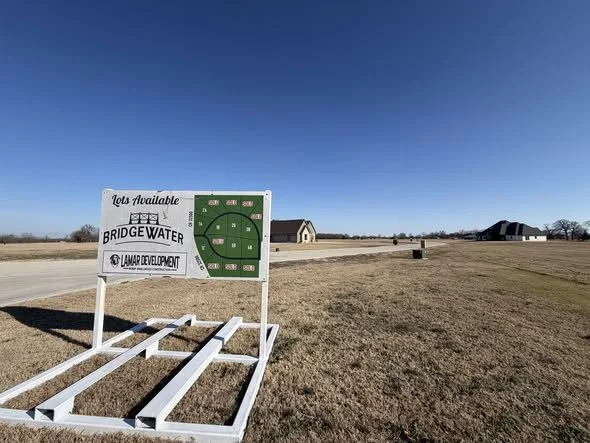Bridgewater development lot map sign and paved road in Paris Texas.