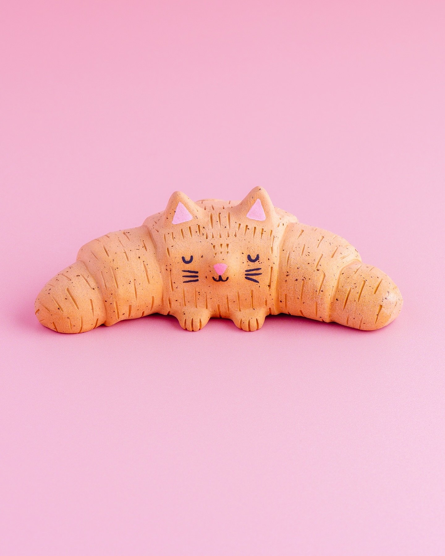 Celine the Croissant Cat 🥐

At the beginning of the year I made a pledge to make more cats out of clay and here is one I made in March! 🐱

Celine is both cat and croissant, both things are wonderful so she doesn&rsquo;t need to choose and is very h