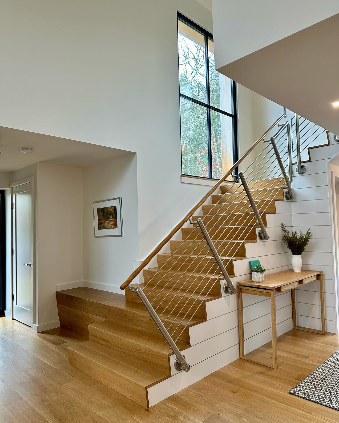 A nautical interpretation of a gangway influenced the design of this staircase. The staircase features a stainless steel railing system and a hardwood handrail. The incorporation of these materials provides strength and durability to the design. The 