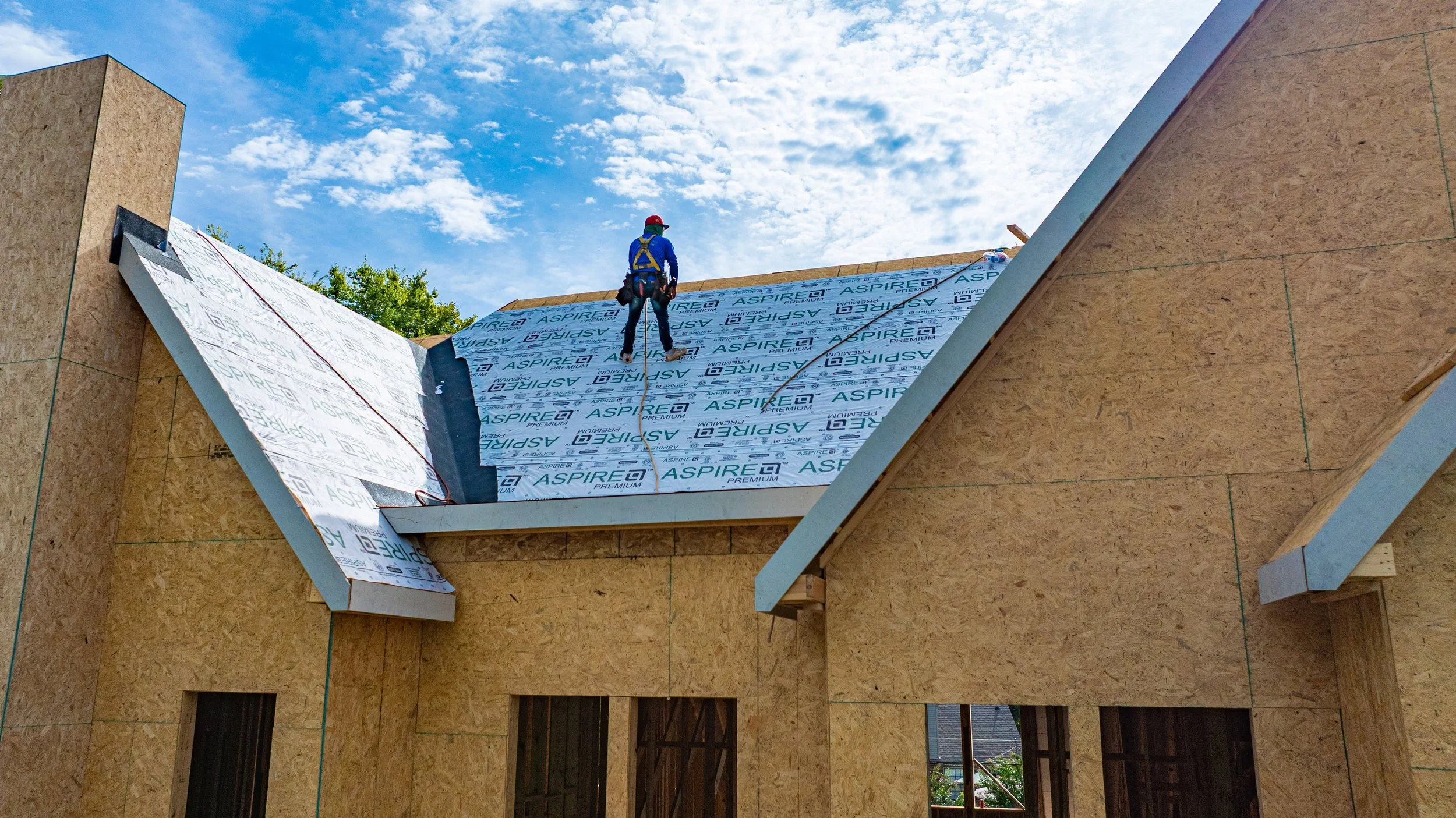 Roofer working on new construction roof install