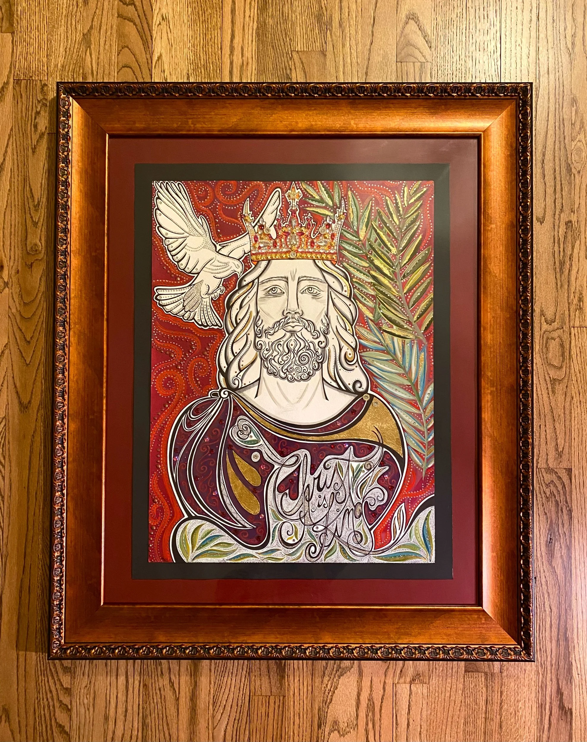 Jesus Christ pictured with a crown of jewels, purple jeweled robe, and white dove flying overhead. Palm leaves framing Jesus
