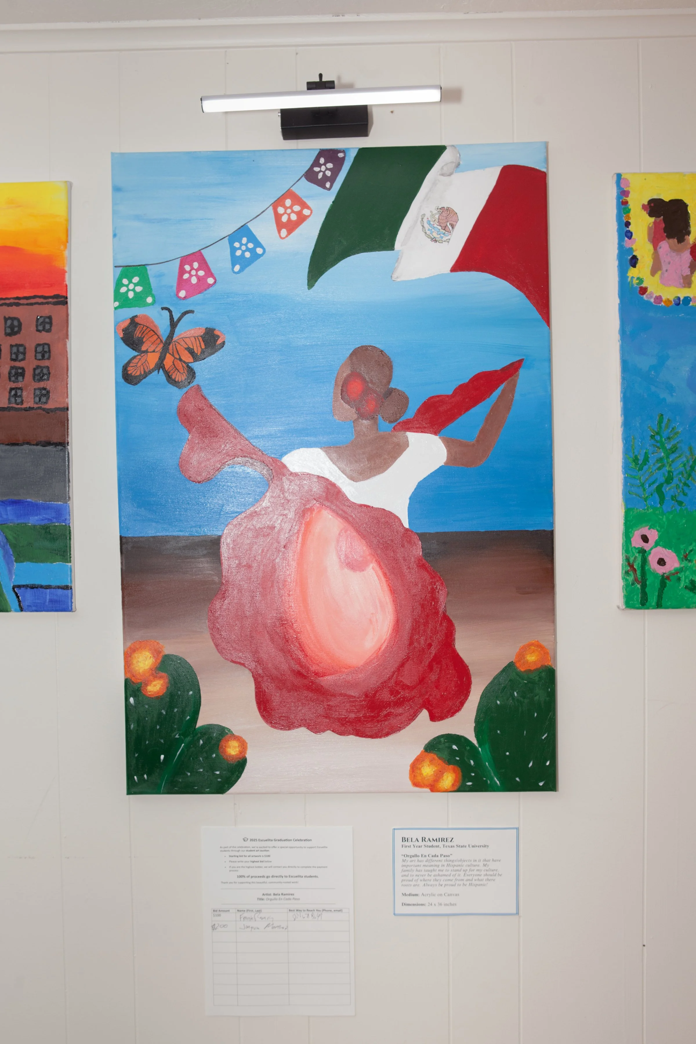 Painting of a woman in a colorful dress, holding a red umbrella, with a Mexican flag and a butterfly in the background, displayed at an art gallery.