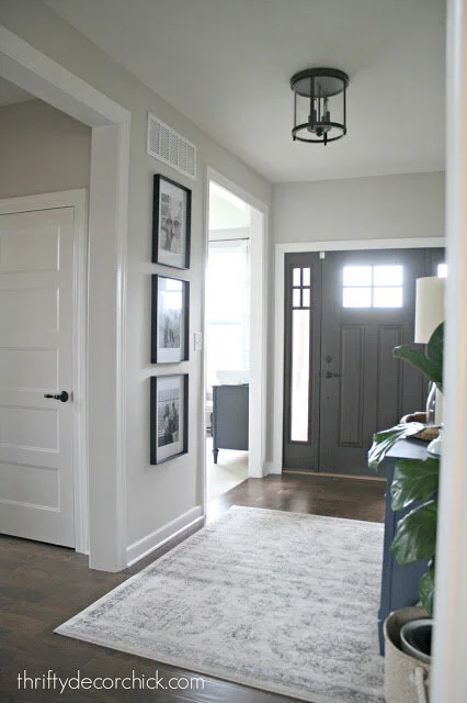 A bright and welcoming foyer with walls painted in Sherwin Williams Repose Gray. Image Source: Thrifty Decor Chick