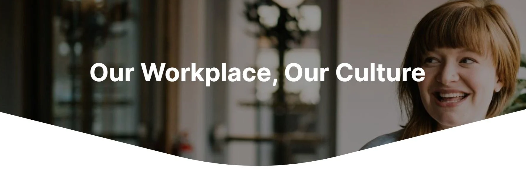 Image of the front page of our eLearning module 1. Part of an image of a blurred background with a young woman to the side and the words "Our workplace, our culture in white over the top of the imageof